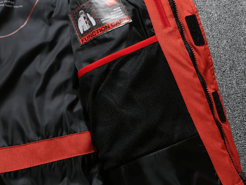 Close-up of interior pocket details on a warm, windproof, waterproof outdoor sports ski suit, featuring red and black design.